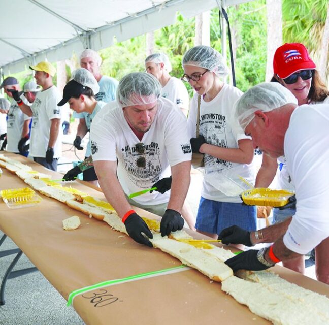Volunteers assembling a section of the 400-foot Cuban sandwich